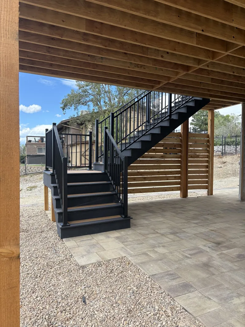 Structural carpentry beneath an outdoor deck in progress